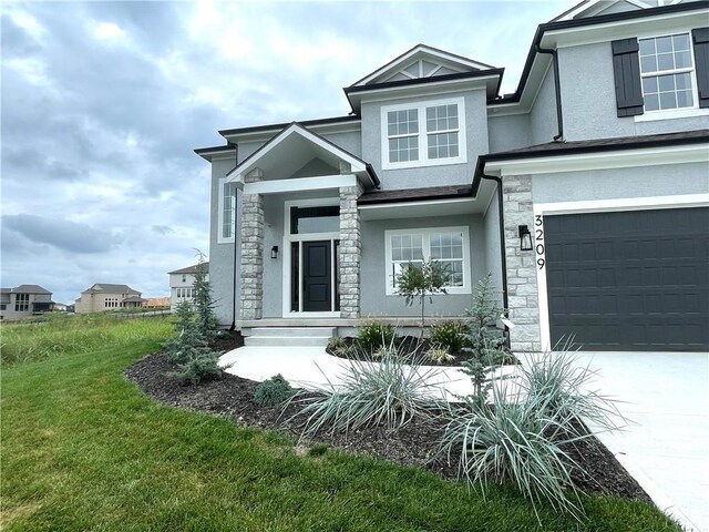 view of front facade with a garage and a front yard