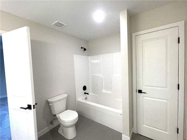 bathroom with a textured ceiling, toilet, and shower / tub combination