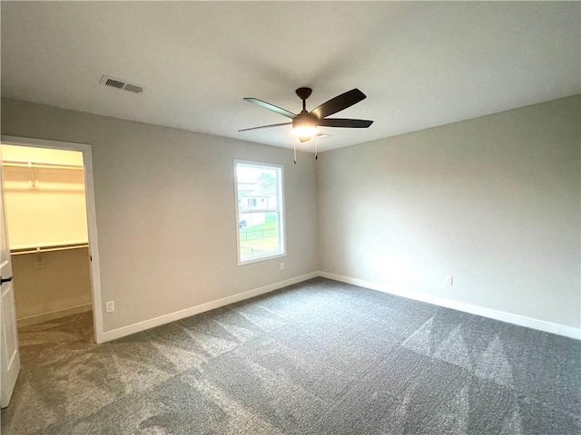 empty room featuring ceiling fan and carpet flooring