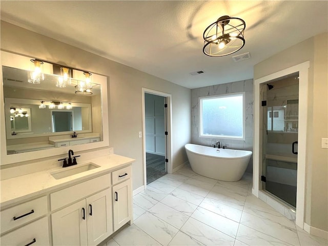 bathroom with vanity and separate shower and tub