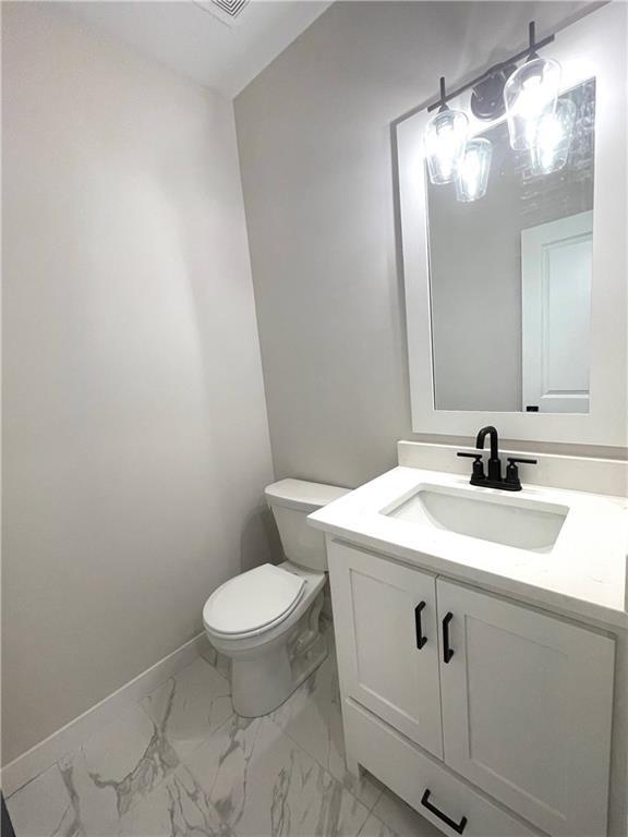 bathroom with vanity and toilet