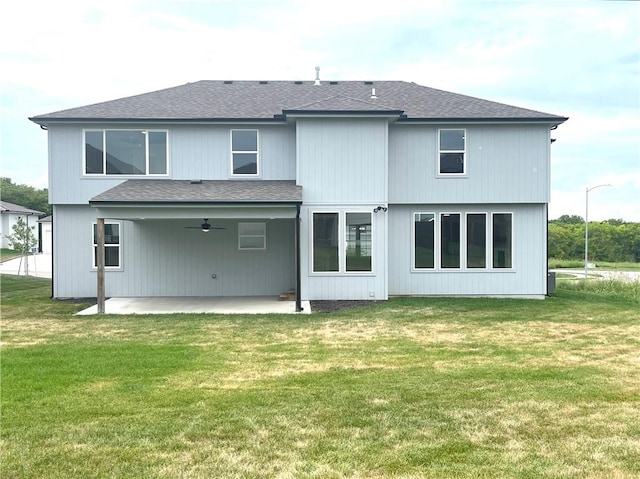 back of property with a yard and a patio