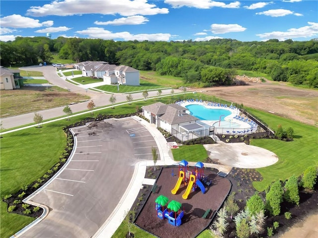 birds eye view of property featuring a view of trees