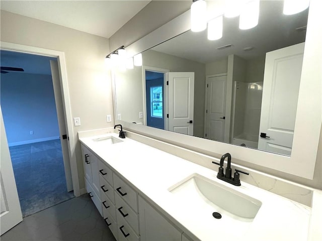 bathroom featuring double vanity, visible vents, walk in shower, and a sink