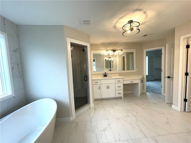 full bath with visible vents, marble finish floor, a shower stall, and a freestanding tub