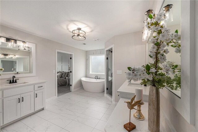 bathroom featuring vanity, a notable chandelier, a freestanding tub, marble finish floor, and visible vents