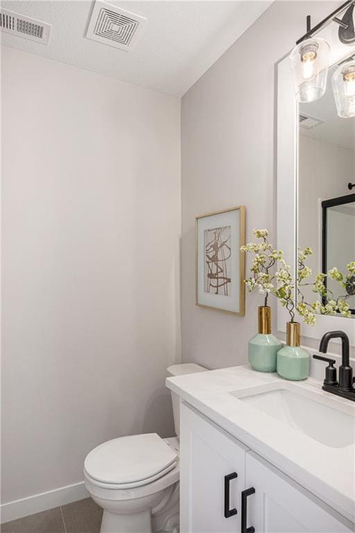 bathroom featuring toilet, tile patterned flooring, visible vents, and vanity