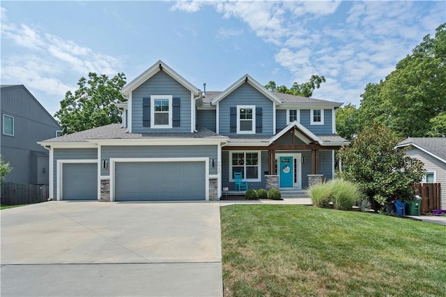 craftsman-style home with a front yard, fence, stone siding, and driveway