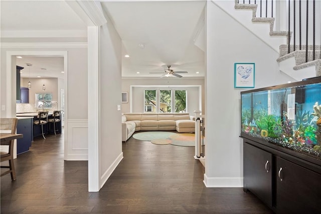 entryway featuring stairway, dark wood-style flooring, baseboards, and ceiling fan