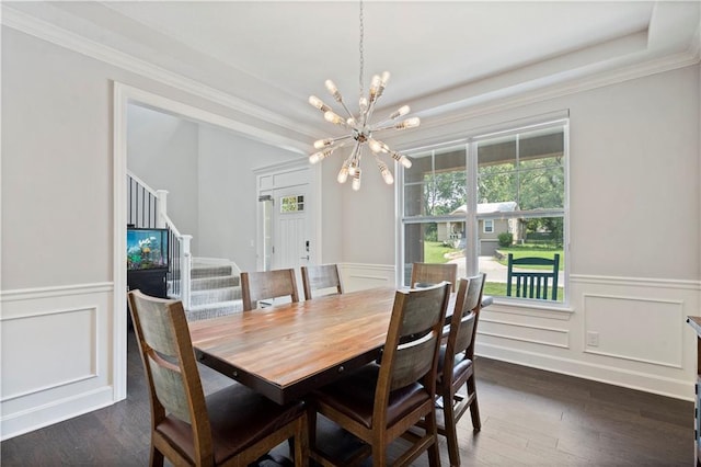 dining area featuring an inviting chandelier, stairs, wainscoting, dark wood finished floors, and a decorative wall
