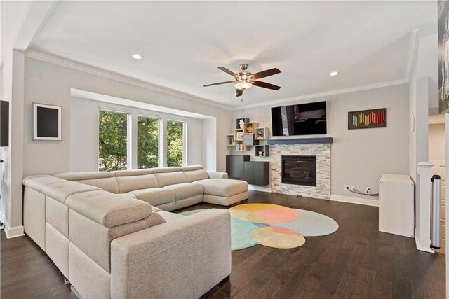 living area featuring crown molding, ceiling fan, baseboards, and dark wood finished floors