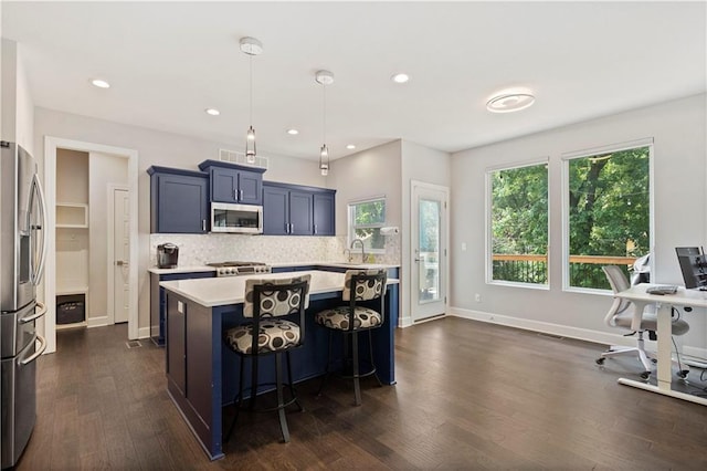 kitchen featuring tasteful backsplash, baseboards, light countertops, dark wood-type flooring, and stainless steel appliances