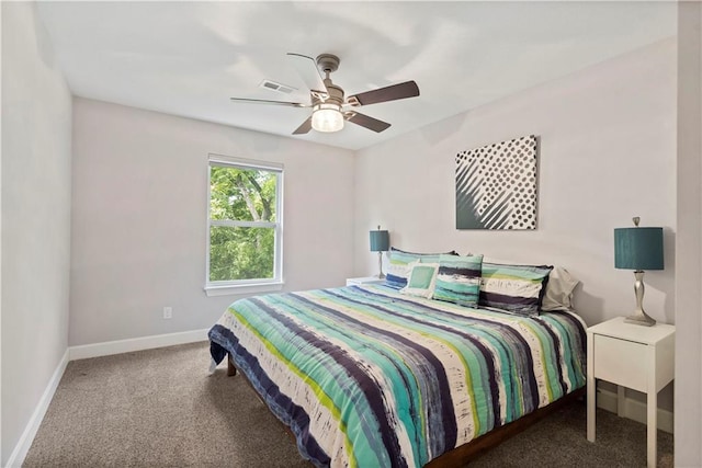 bedroom with ceiling fan, baseboards, and carpet floors