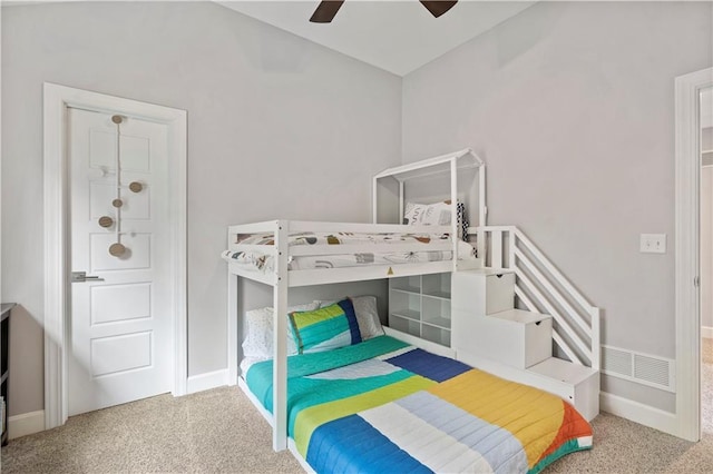 carpeted bedroom with vaulted ceiling, baseboards, a ceiling fan, and visible vents
