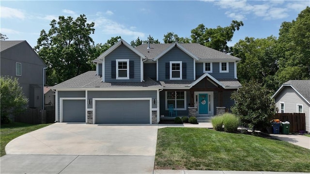 craftsman house featuring a front yard, stone siding, a garage, fence, and concrete driveway