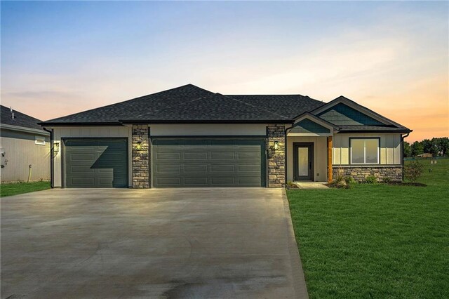 view of front of property with a lawn and a garage