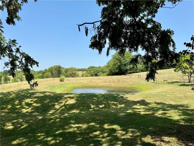 exterior space featuring a water view and a lawn