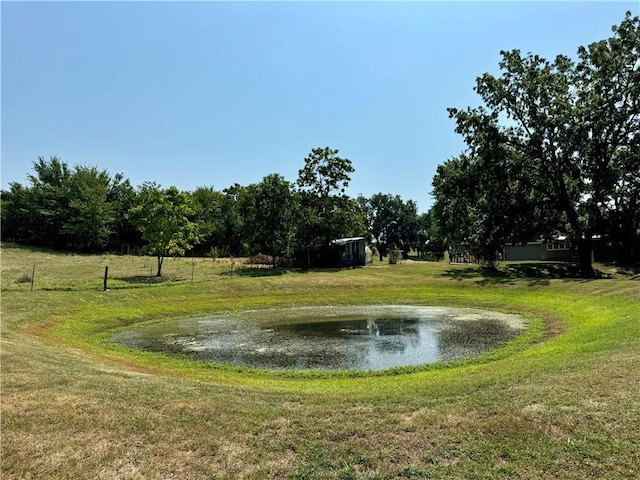 view of community featuring a water view and a yard