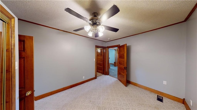 carpeted spare room with ceiling fan and a textured ceiling