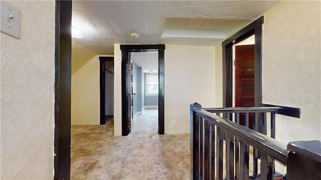 hallway featuring light carpet