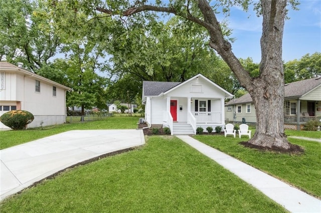 view of front of home with covered porch and a front yard