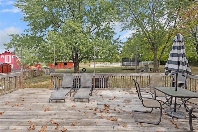 wooden deck featuring a lawn