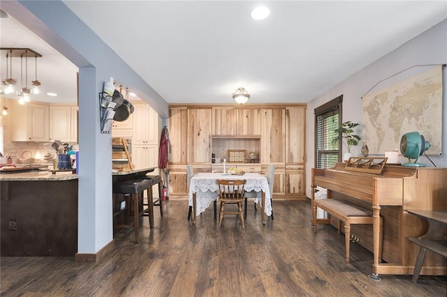 dining space with dark hardwood / wood-style floors