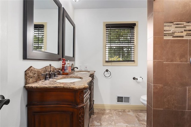 bathroom featuring vanity and toilet