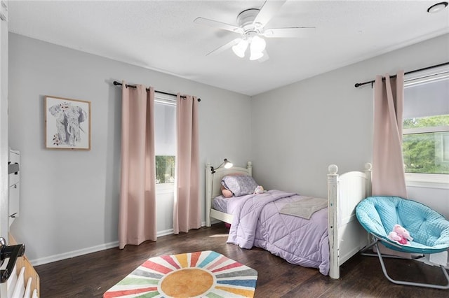 bedroom featuring dark hardwood / wood-style flooring and ceiling fan