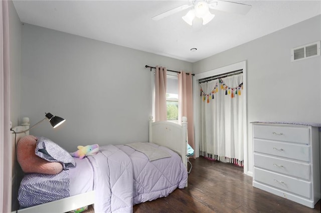 bedroom with ceiling fan, dark hardwood / wood-style floors, and a closet