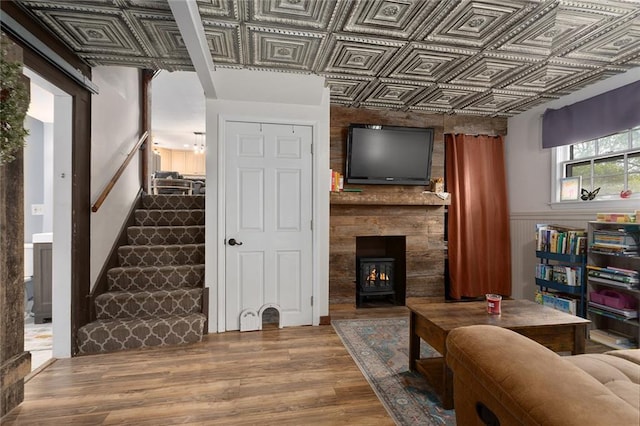 living room featuring a large fireplace and hardwood / wood-style flooring