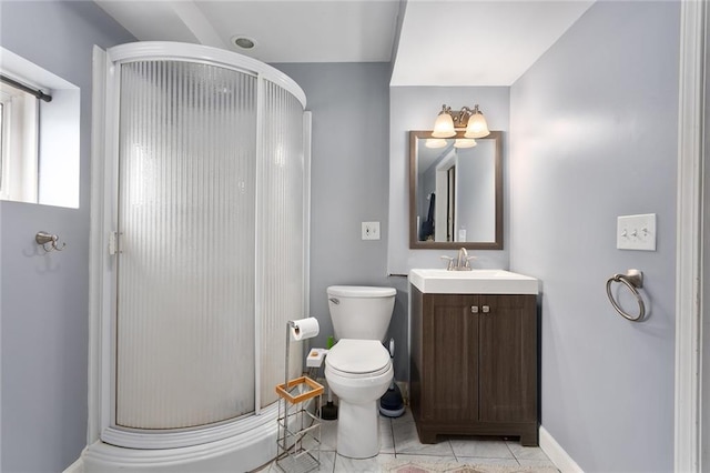 bathroom featuring vanity, toilet, and a shower with shower door