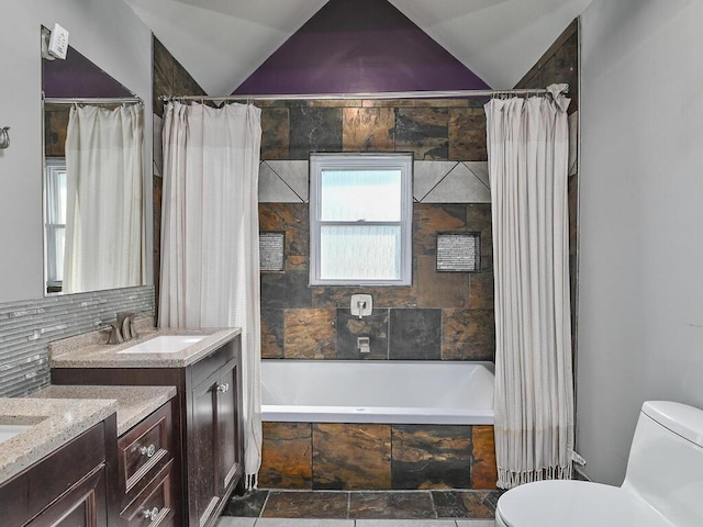 full bathroom featuring shower / tub combo, vanity, vaulted ceiling, and toilet