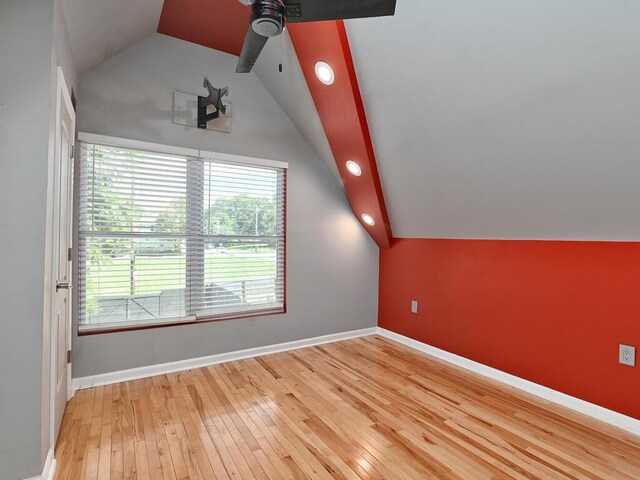 bonus room with hardwood / wood-style flooring, vaulted ceiling, and ceiling fan