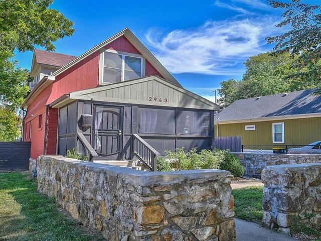 rear view of house with a sunroom