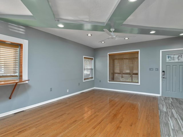 empty room with ceiling fan and light wood-type flooring