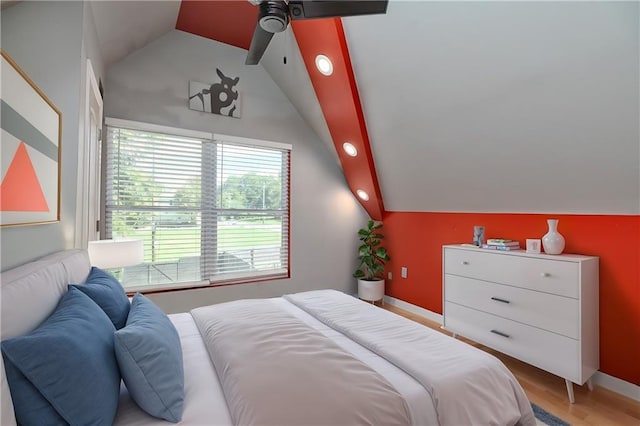 bedroom with lofted ceiling and light hardwood / wood-style floors