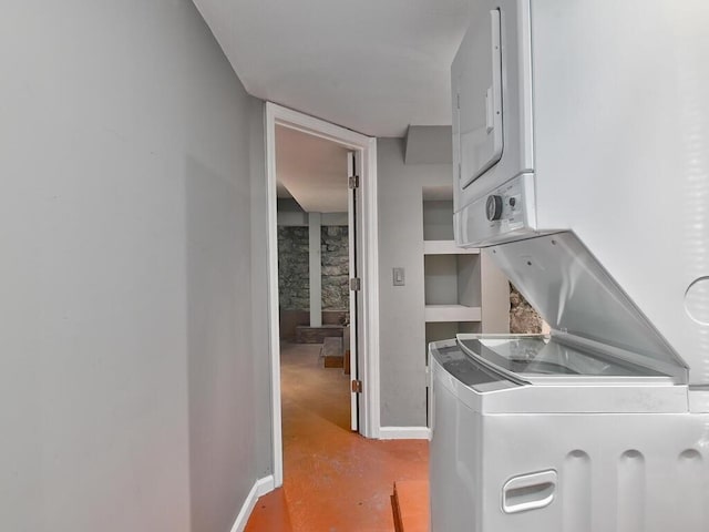 laundry area with stacked washer and dryer