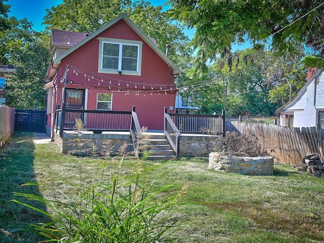 back of house with a yard and a deck