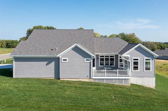 rear view of house featuring a yard and a deck