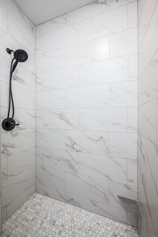 bathroom with tiled shower