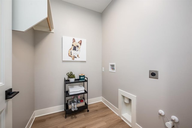 washroom with washer hookup, light wood-style flooring, hookup for an electric dryer, gas dryer hookup, and laundry area