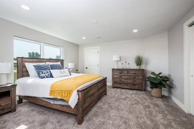 carpeted bedroom featuring baseboards and recessed lighting