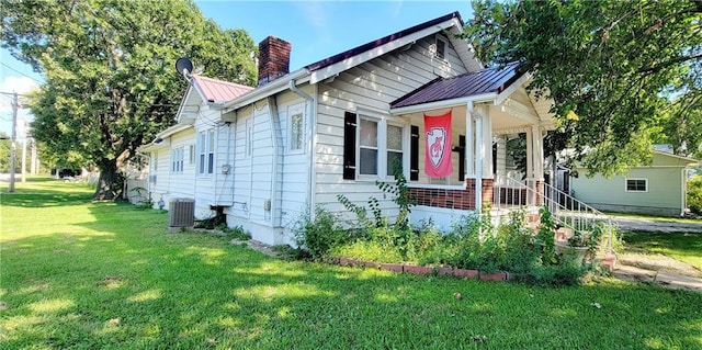 exterior space featuring a front yard, central AC unit, and a porch