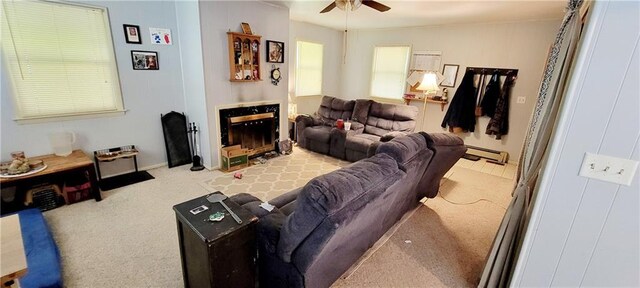 carpeted living room featuring ceiling fan and a baseboard radiator