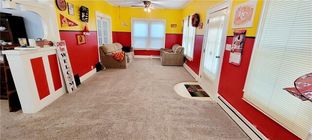 game room with a baseboard heating unit, carpet flooring, and ceiling fan