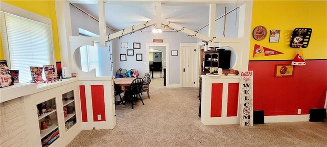 interior space with vaulted ceiling and carpet