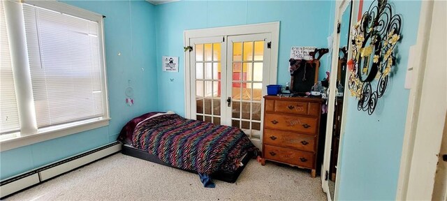 bedroom featuring french doors, multiple windows, a baseboard radiator, and carpet floors