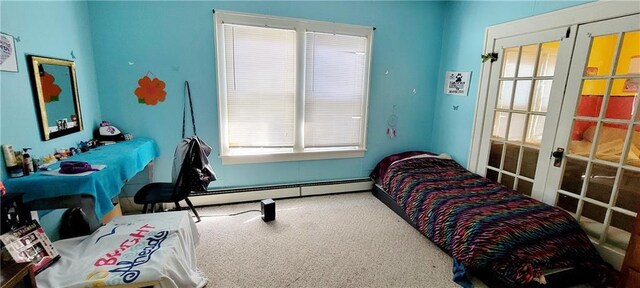 carpeted bedroom featuring french doors and baseboard heating