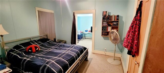 carpeted bedroom with a baseboard radiator